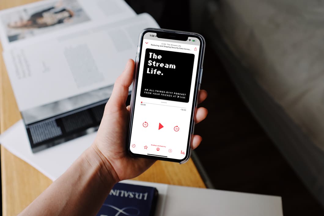 mockuuups-iphone-12-pro-mockup-held-by-user-over-textbooks