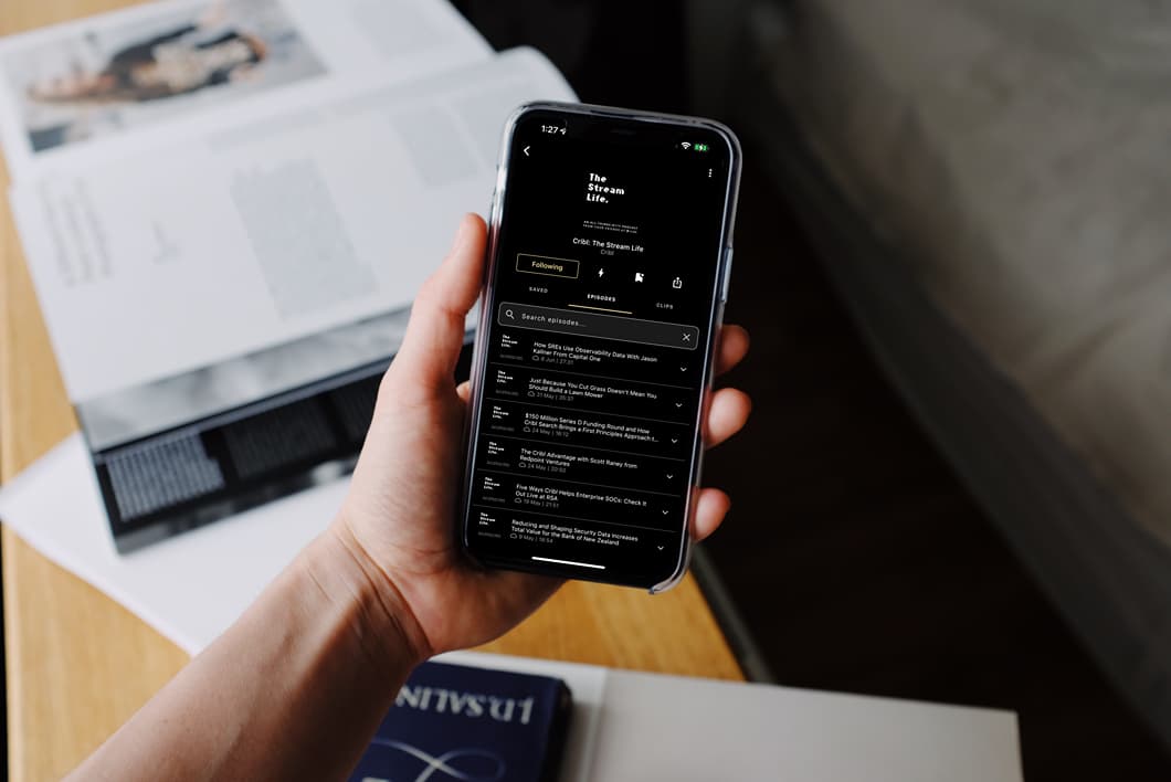 mockuuups-iphone-12-pro-mockup-held-by-user-over-textbooks
