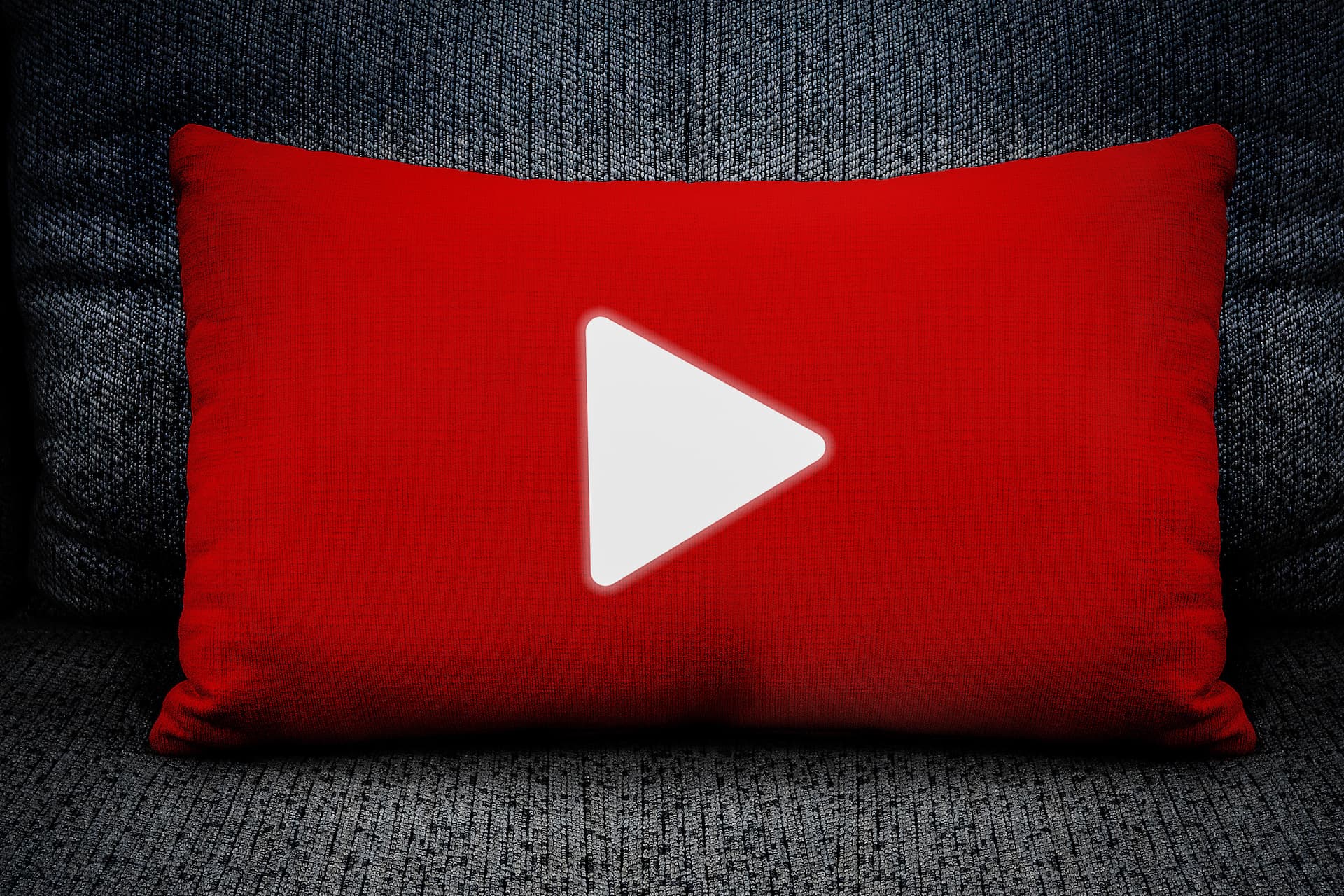 The symbol begins with a white triangle on a red pillow placed on the sofa, concepts, communication and technology.