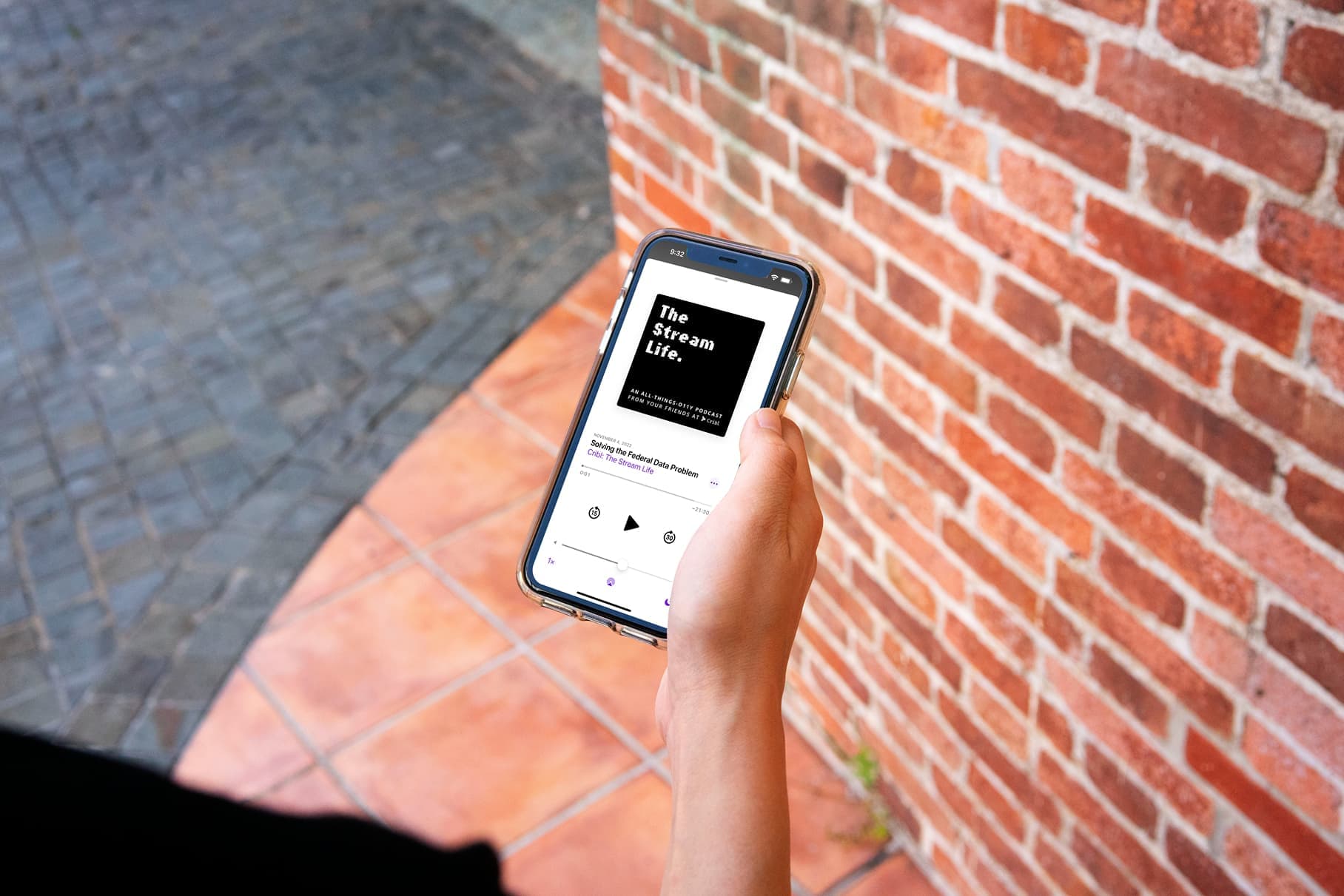 mockuuups-iphone-mockup-held-beside-a-brick-wall